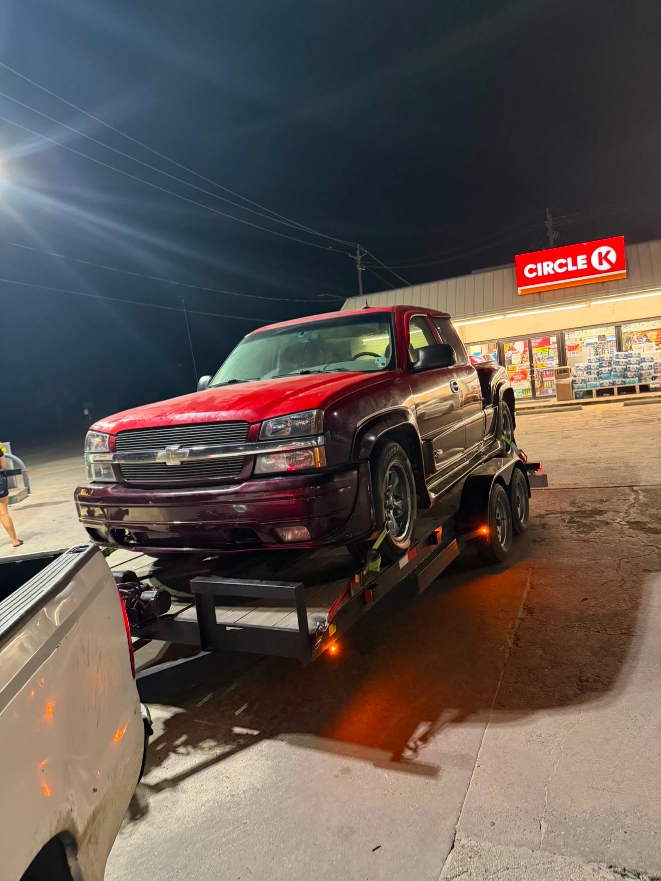Masterkey Transport towing a pickup truck at night in Houston, Texas